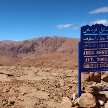 On the summit of Jbel Asstef. Two notes: The peak is 1961 meters high and you can see the three different scripts in Morocco - the top two lines Arabic, Berber and Latin below